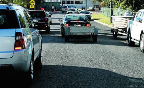 Vehicles travelling in different directions on Hudson St are unable to do so and one car is forced to wait while the other passes. Vehicles travelling in different directions on Hudson St are unable to do so and one car is forced to wait while the other passes.
